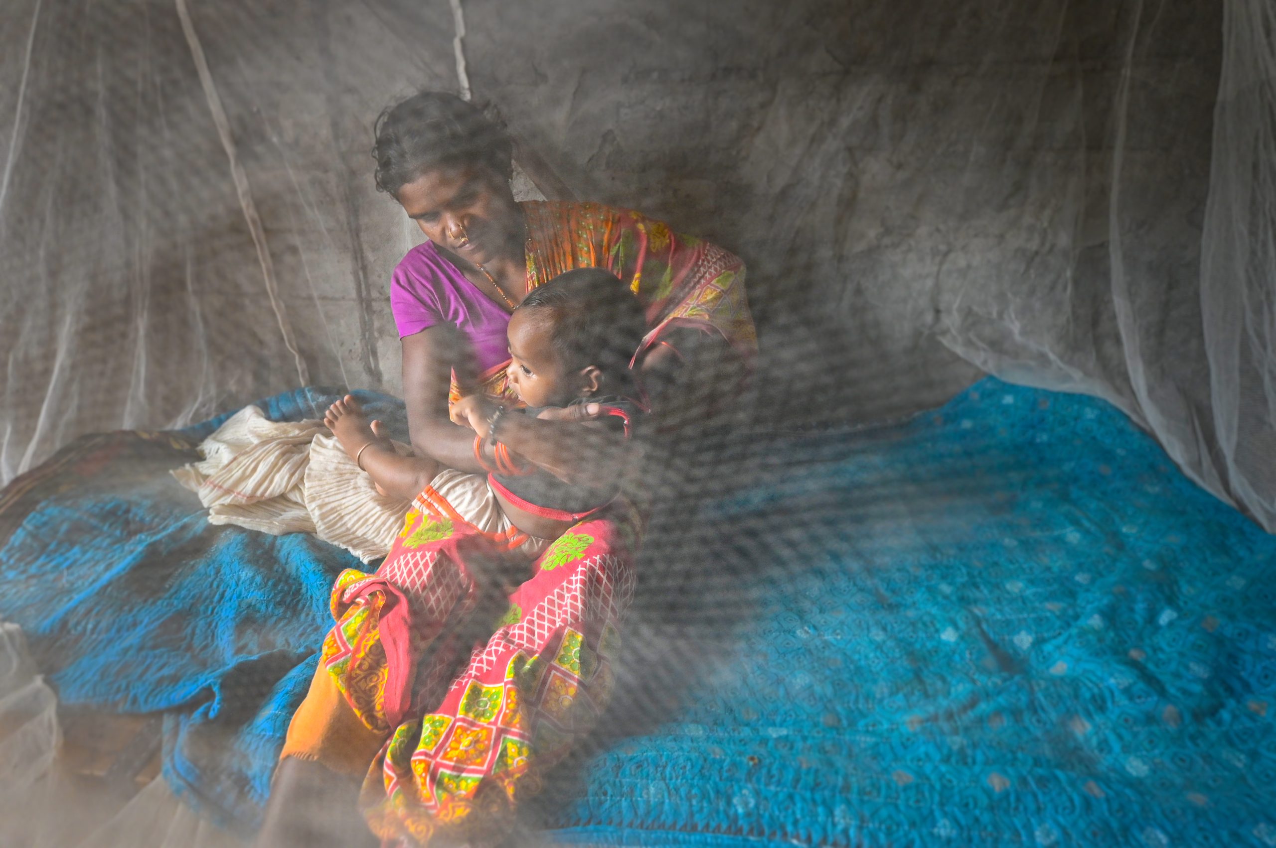 A mother and her baby under a mosquito net, India, 2022. Photograph: Malaria No More A mother and her baby under a mosquito net, India, 2022. Photograph: Malaria No More